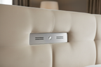Close-up of cream velvet fabric and pop-up TV mechanism on headboard
