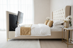Cream velvet TV bed with TV screen raised from foot end, side view