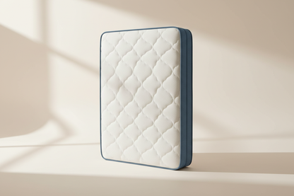 Novera Comfort Hybrid Mattress with a quilted white cover and slate-blue edge on a warm white studio background